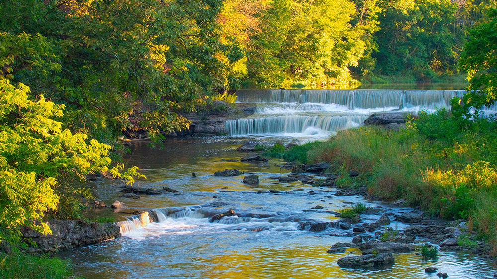 waterfalls tranquil scene of a stream with multiple waterfalls onto small rocks